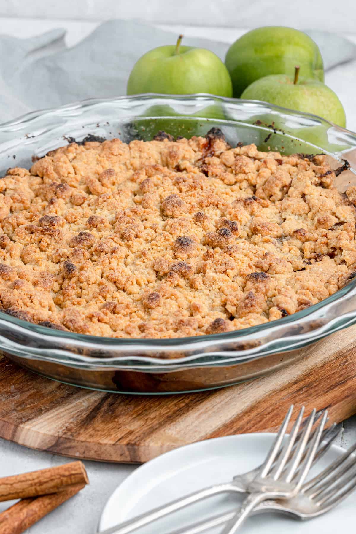 golden baked dutch apple pie in a glass pie plate