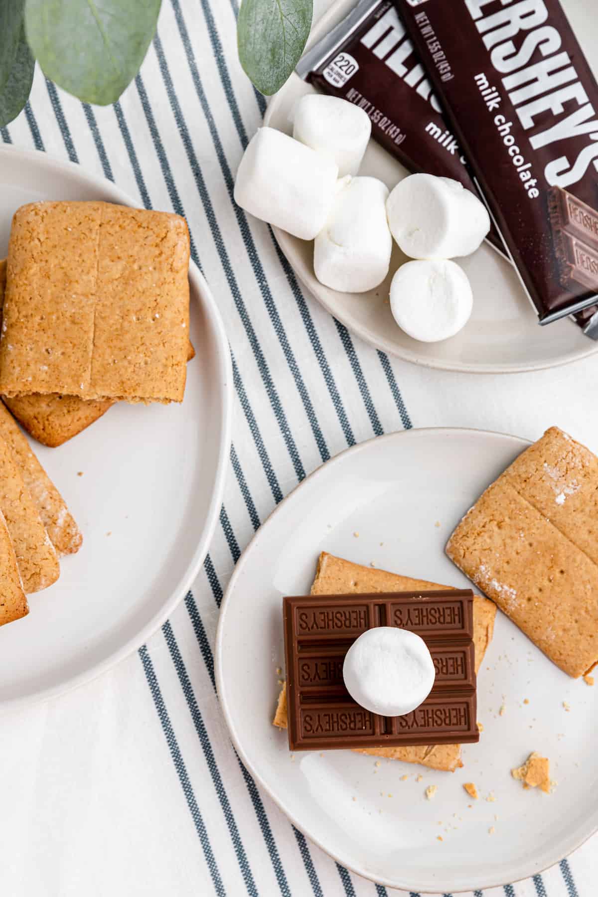 graham crackers with chocolate and marshmallows on plates