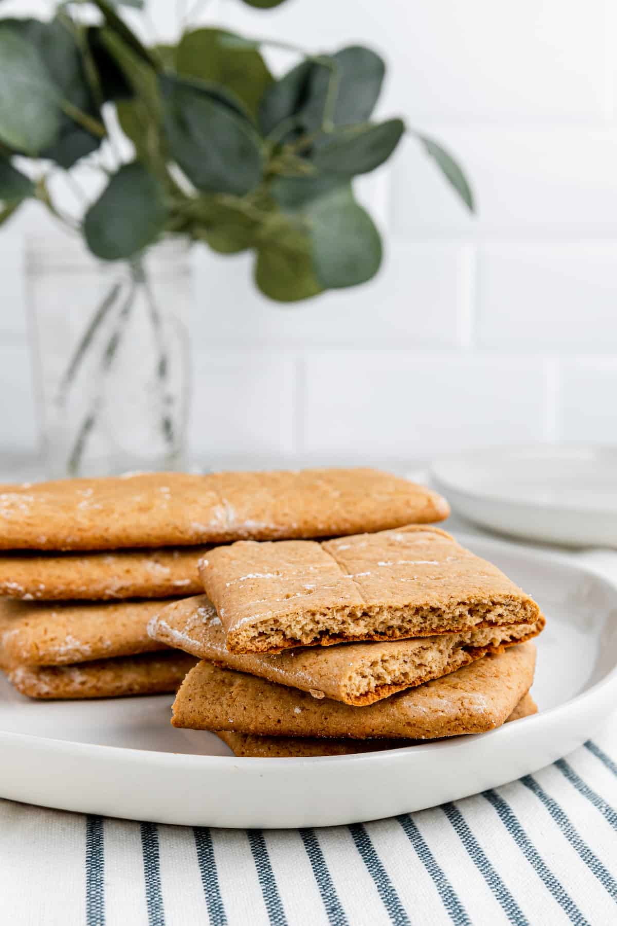 stack of gluten free graham crackers on a white plate