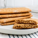 stack of gluten free graham crackers on a white plate