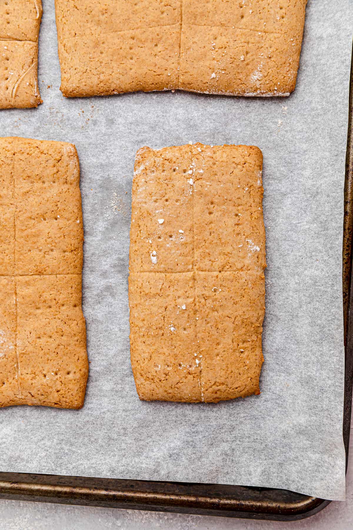 baked graham crackers on a parchment-lined baking sheet