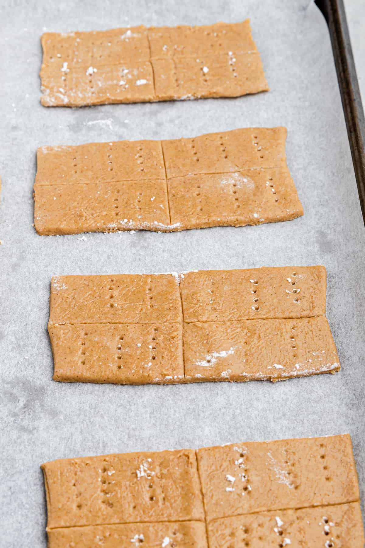 graham crackers on a parchment-lined baking sheet