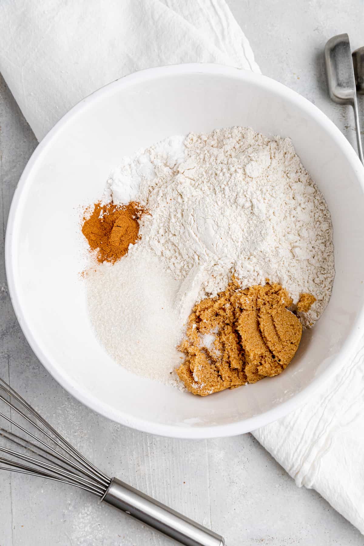 dry ingredients flour, cinnamon, baking powder and salt in a white mixing bowl