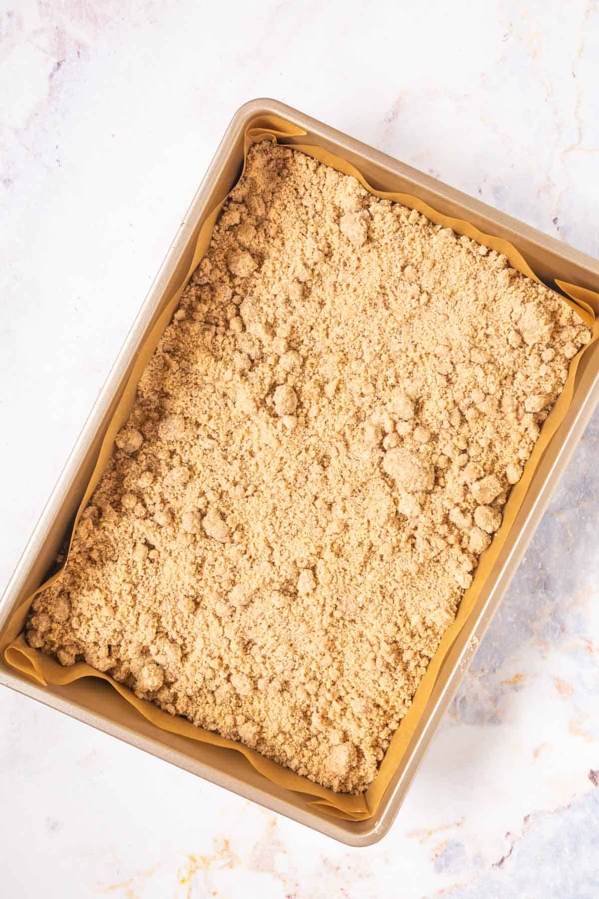 crumb cake with streusel topping in a baking dish before baking