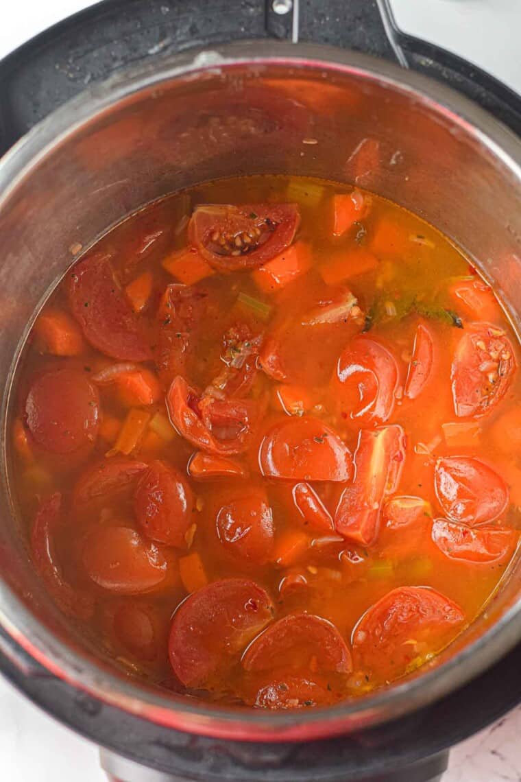 Simmered tomatoes and soup ingredients inside the instant pot.