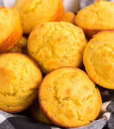 gluten free cornbread muffins in a black and white plaid cloth napkin-lined basket