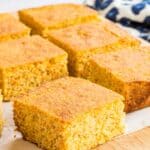 gluten free cornbread cut into squares on a cutting board