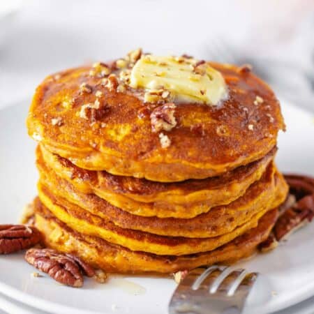 stack of pumpmin pancakes with butter on top