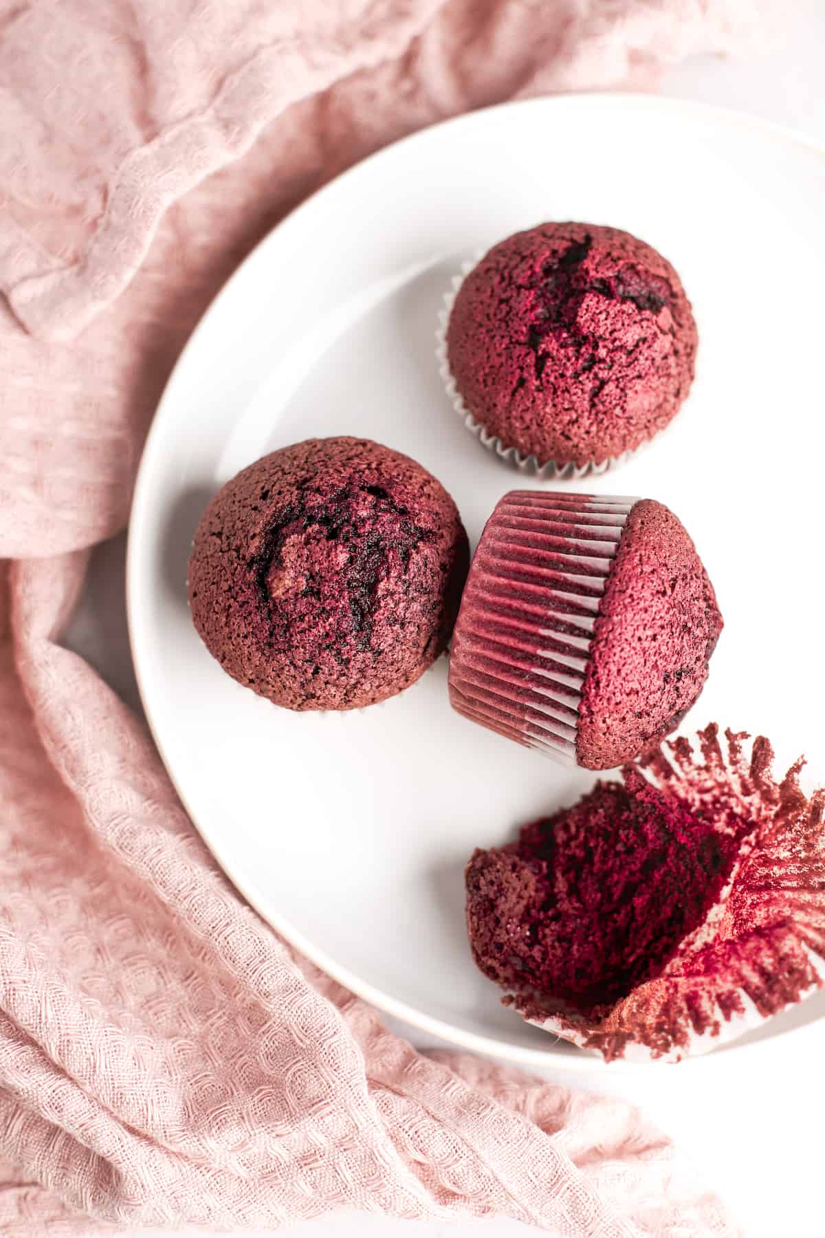 unfrosted red velvet cupcakes on a white plate