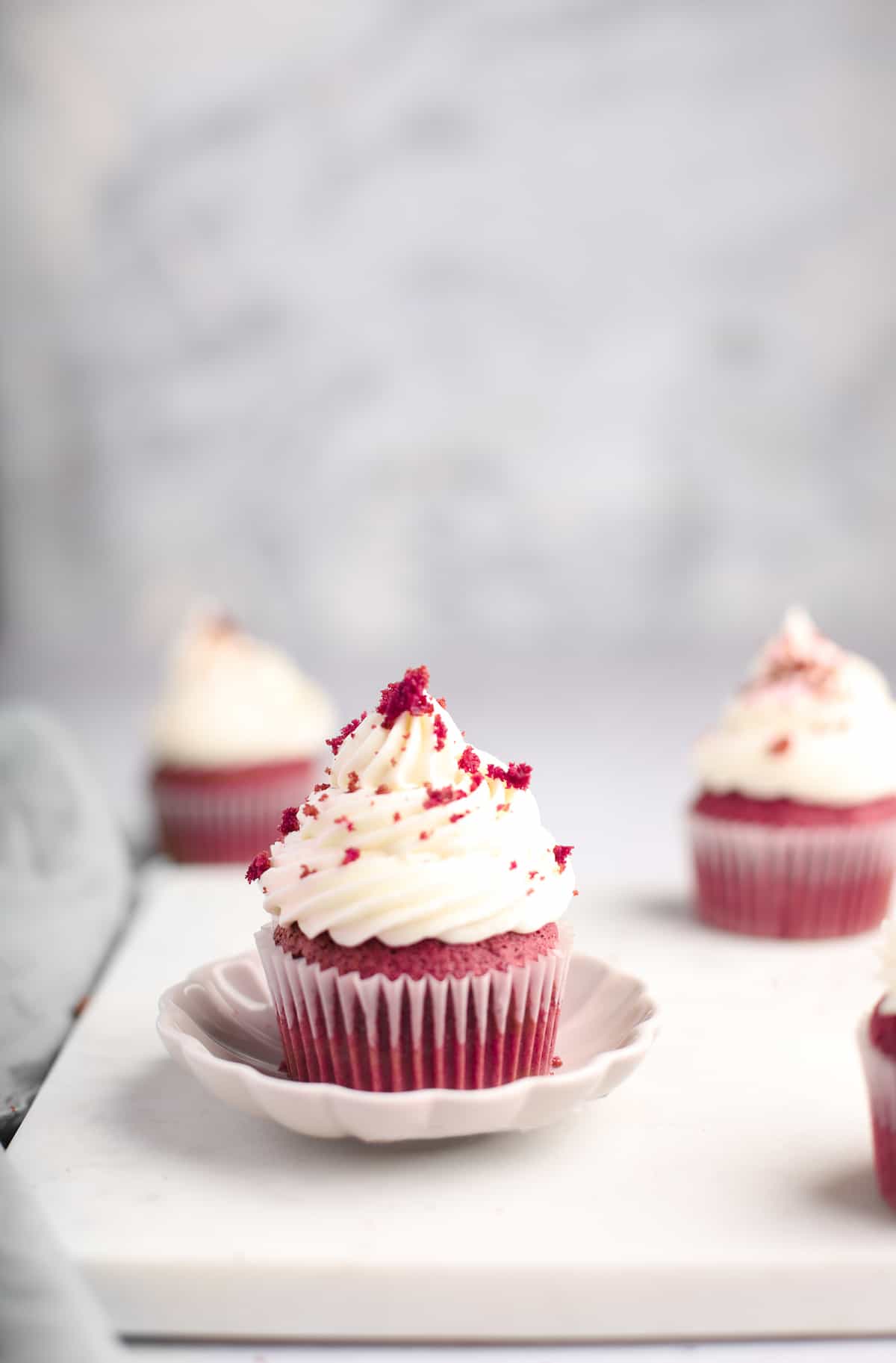 a single red velvet cupcake with the wrapper removed