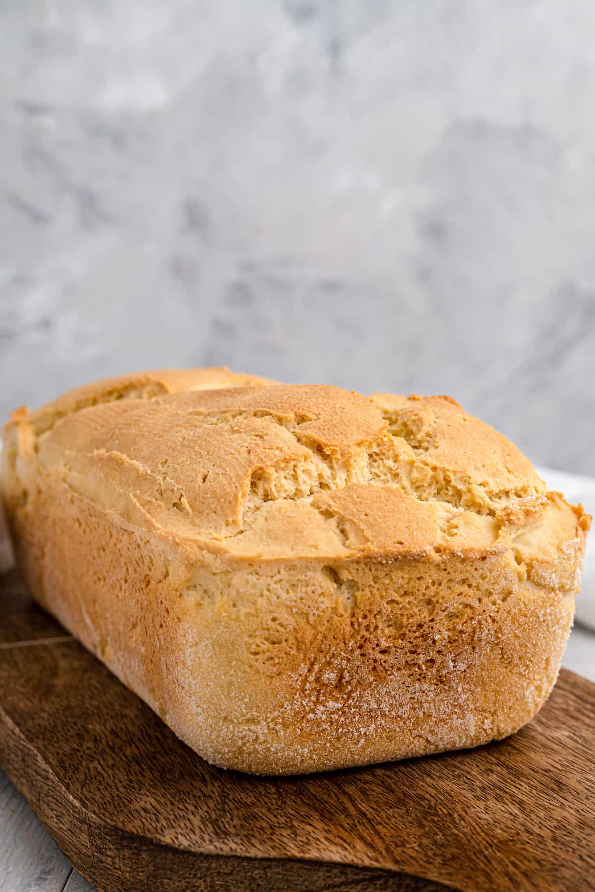 whole loaf of sandwich bread on a wooden cutting board