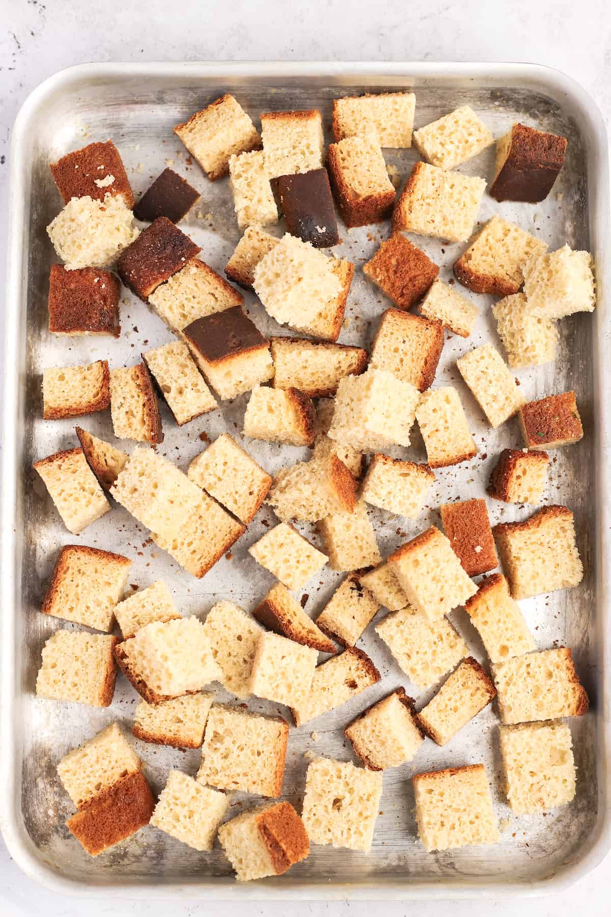 uncooked bread cubes on a baking sheet