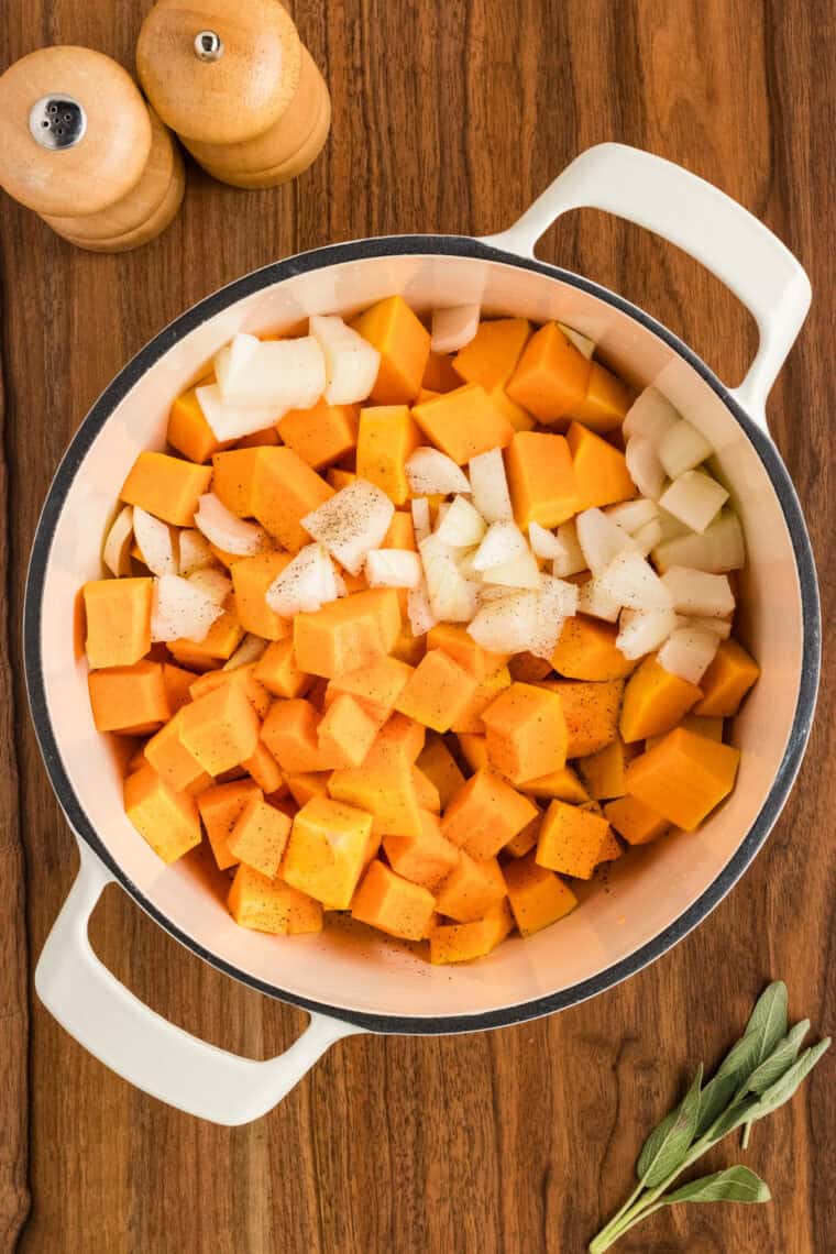 Butternut squash and onions in a pot.