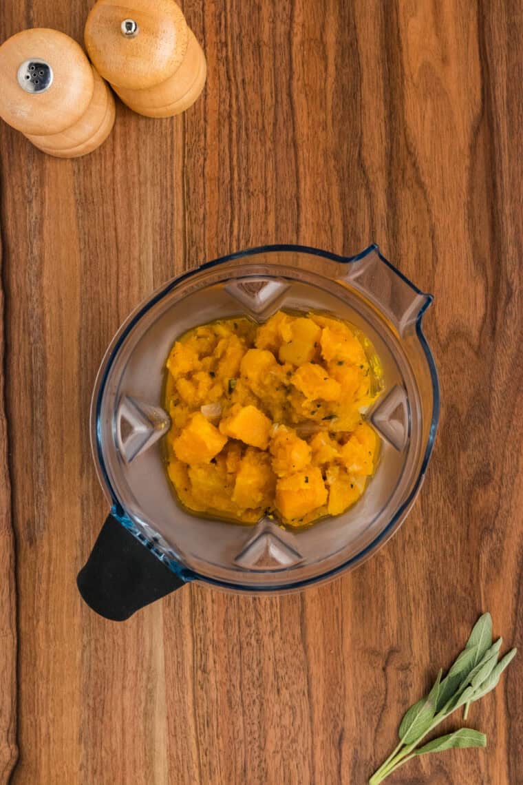 Cooked butternut squash in a blender.