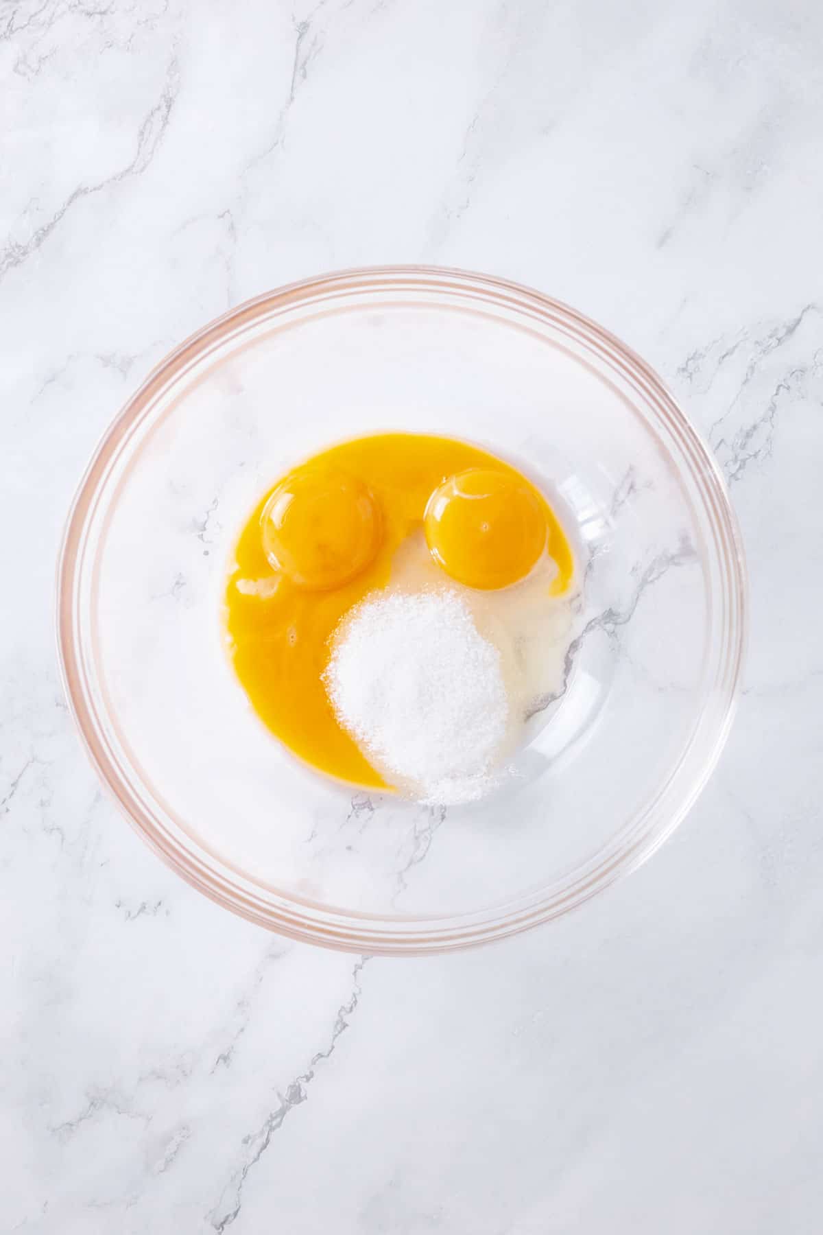 bowl with egg yolks and sugar