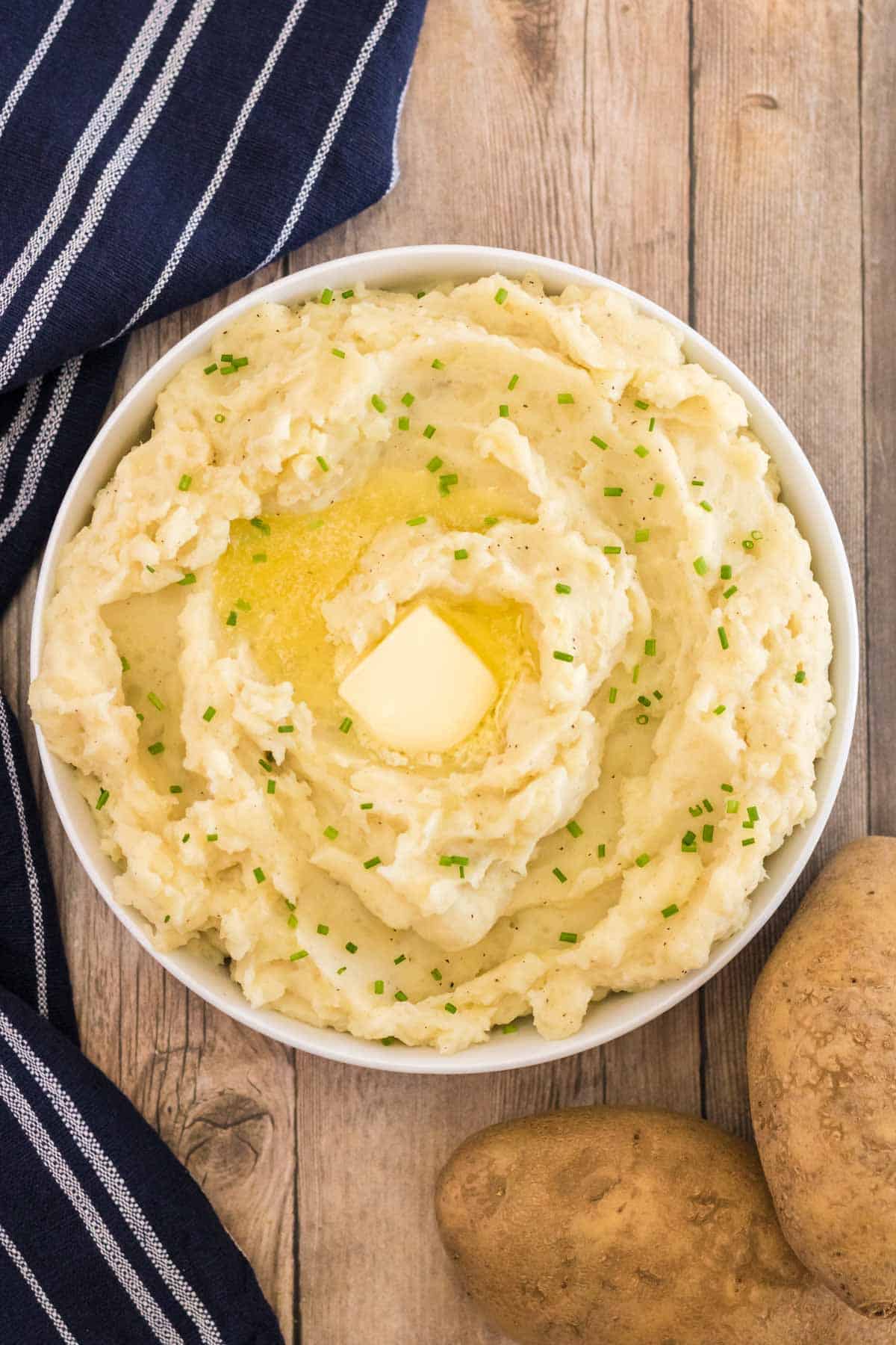 bowl of mashed potatoes with butter and chives