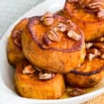 Pumpkin Pie Spice Melting Sweet Potatoes with maple glazed pecans on in a casserole dish