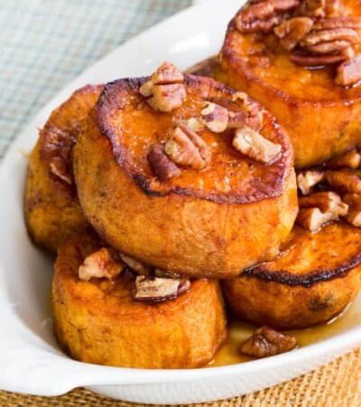 Pumpkin Pie Spice Melting Sweet Potatoes with maple glazed pecans on in a casserole dish