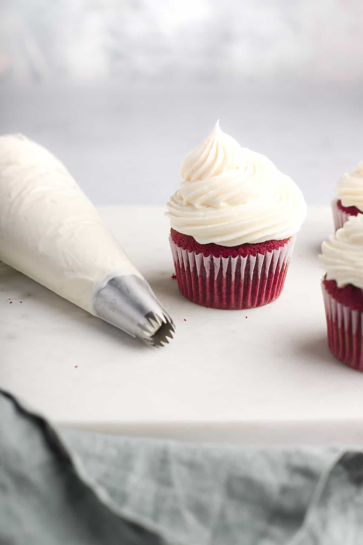 cupcakes and frosting in a piping bag