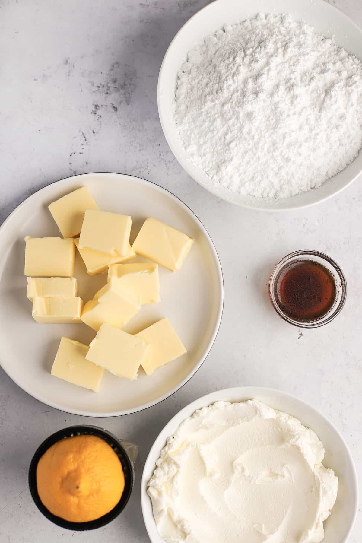 ingredients for vanilla cream cheese frosting in bowls