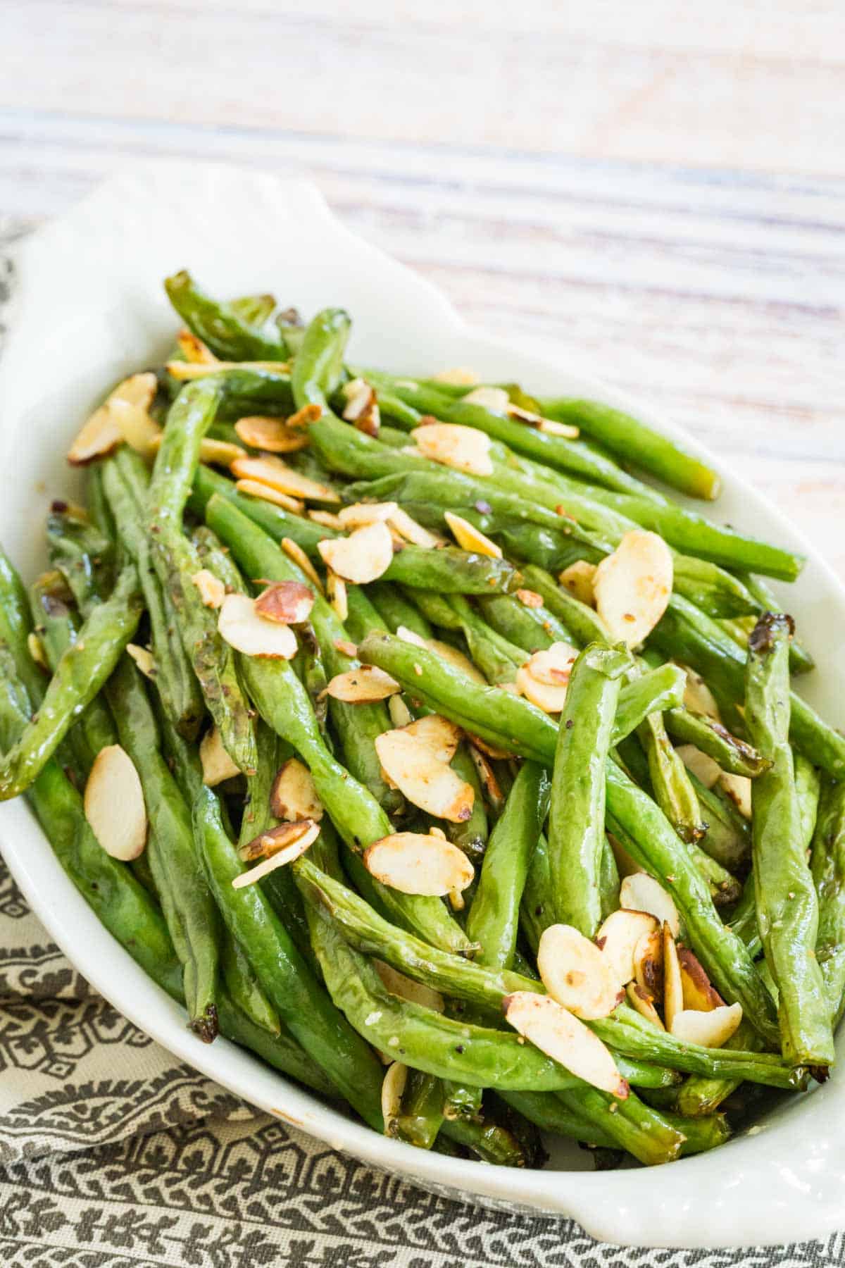 white bowl of air fryer green beans with almonds