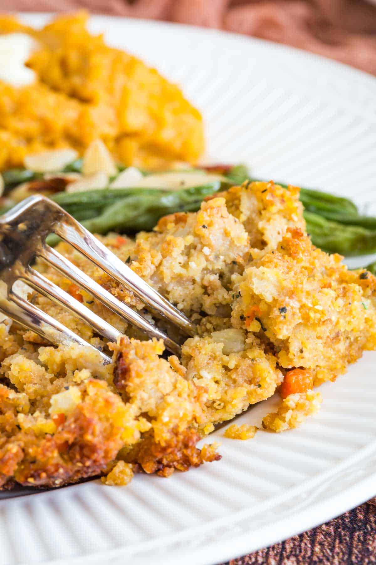 fork taking a bite of gluten free cornbread with green beans