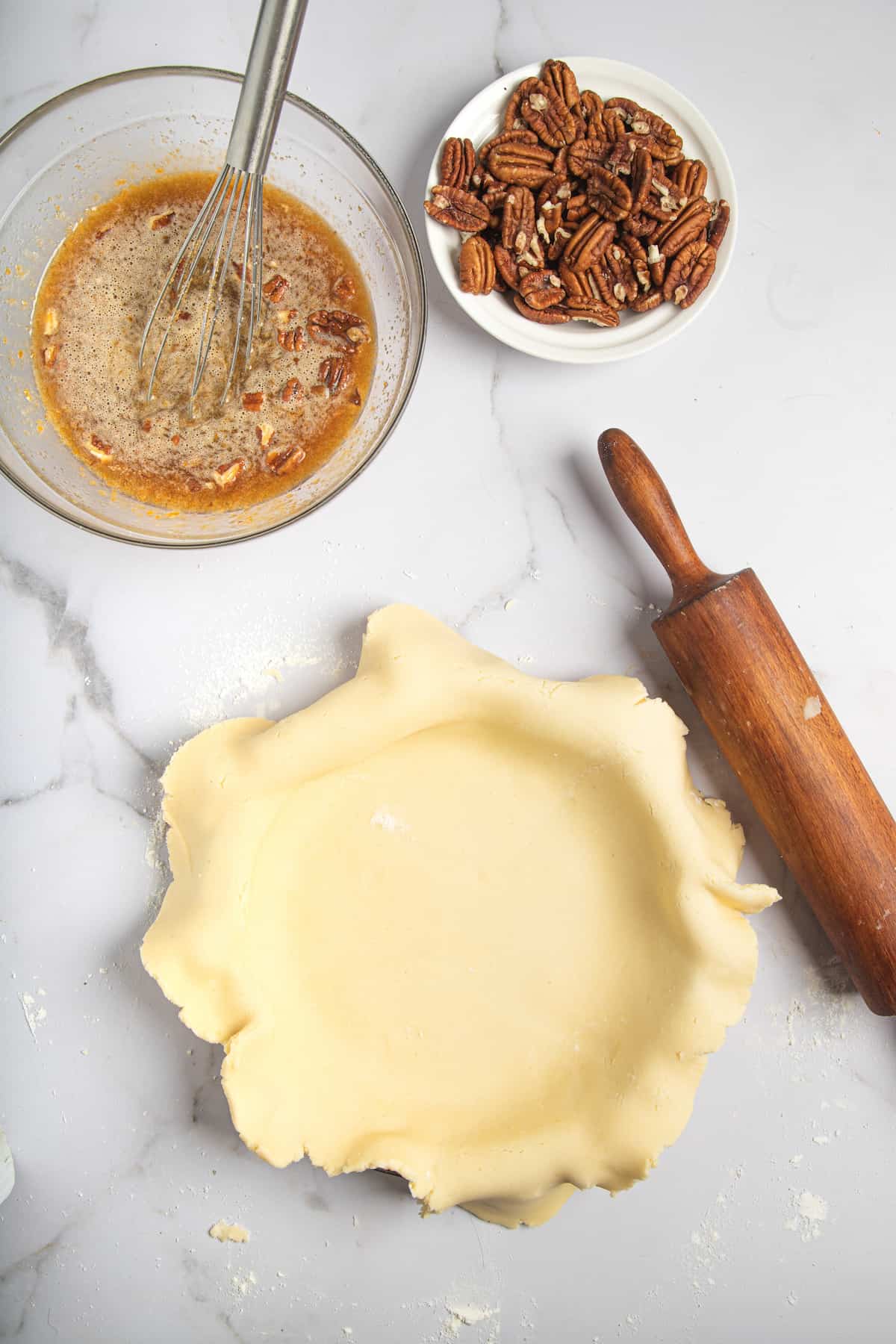 laying pie crust into a pie plate