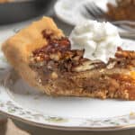 slice of pecan pie topped with whipped cream
