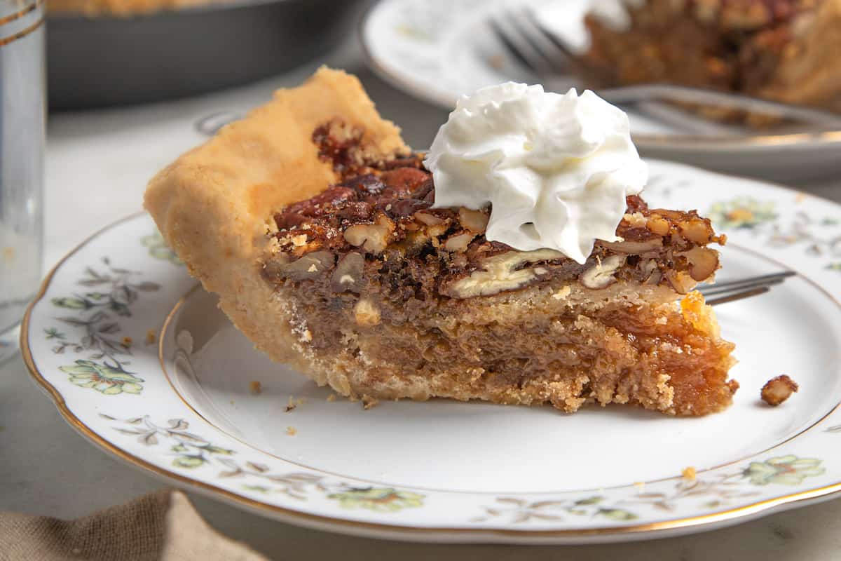 slice of pecan pie topped with whipped cream