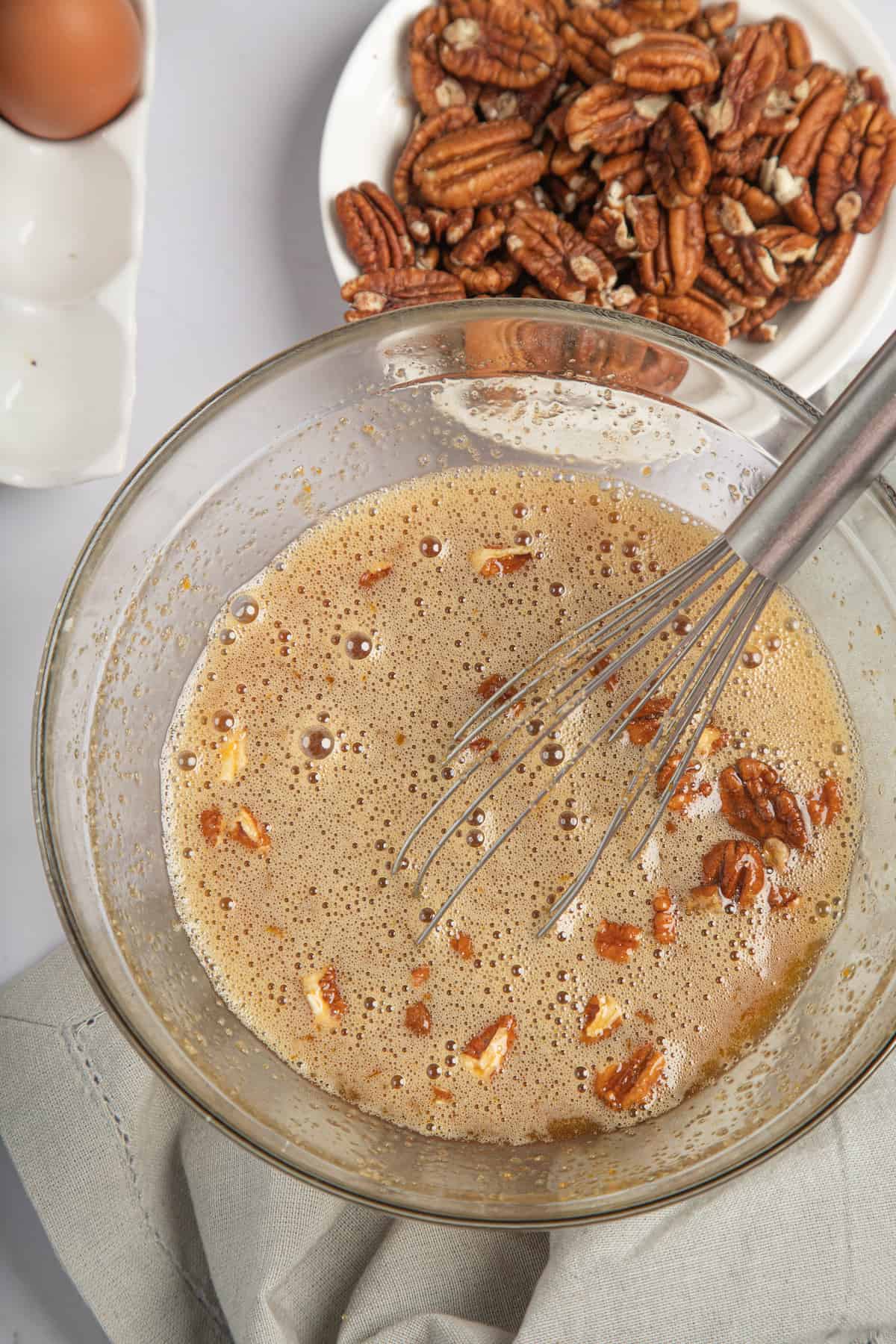 mixing filling for pecan pie in a bowl