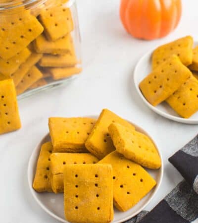 rectangluar gluten free pumpkin cookies on plates and in a jar with a black and white checked cloth napkin