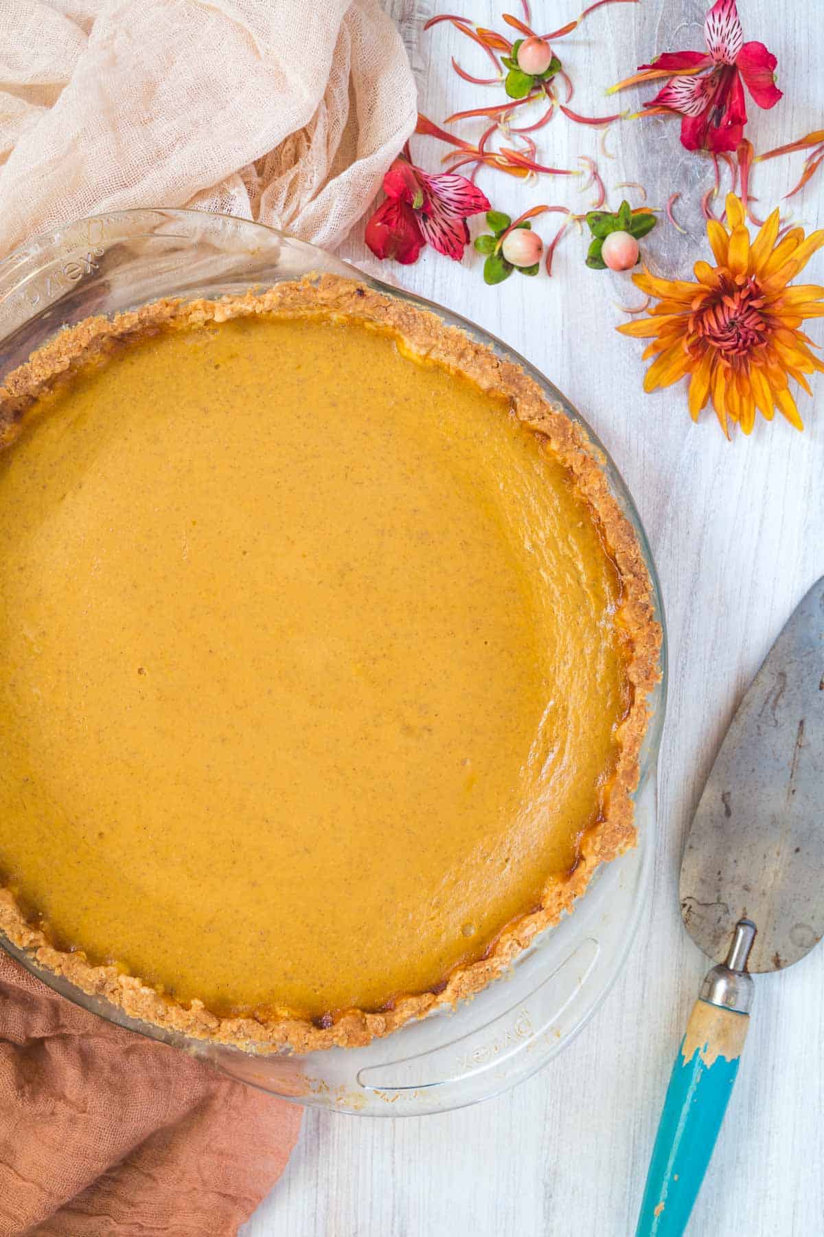 whole pumpkin pie on a white table