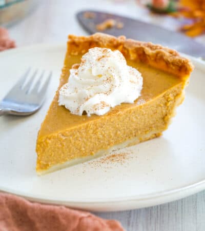 slice of pumpkin pie with whipped cream