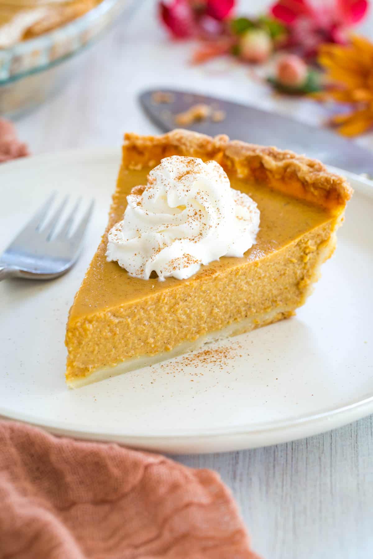 slice of pumpkin pie with whipped cream