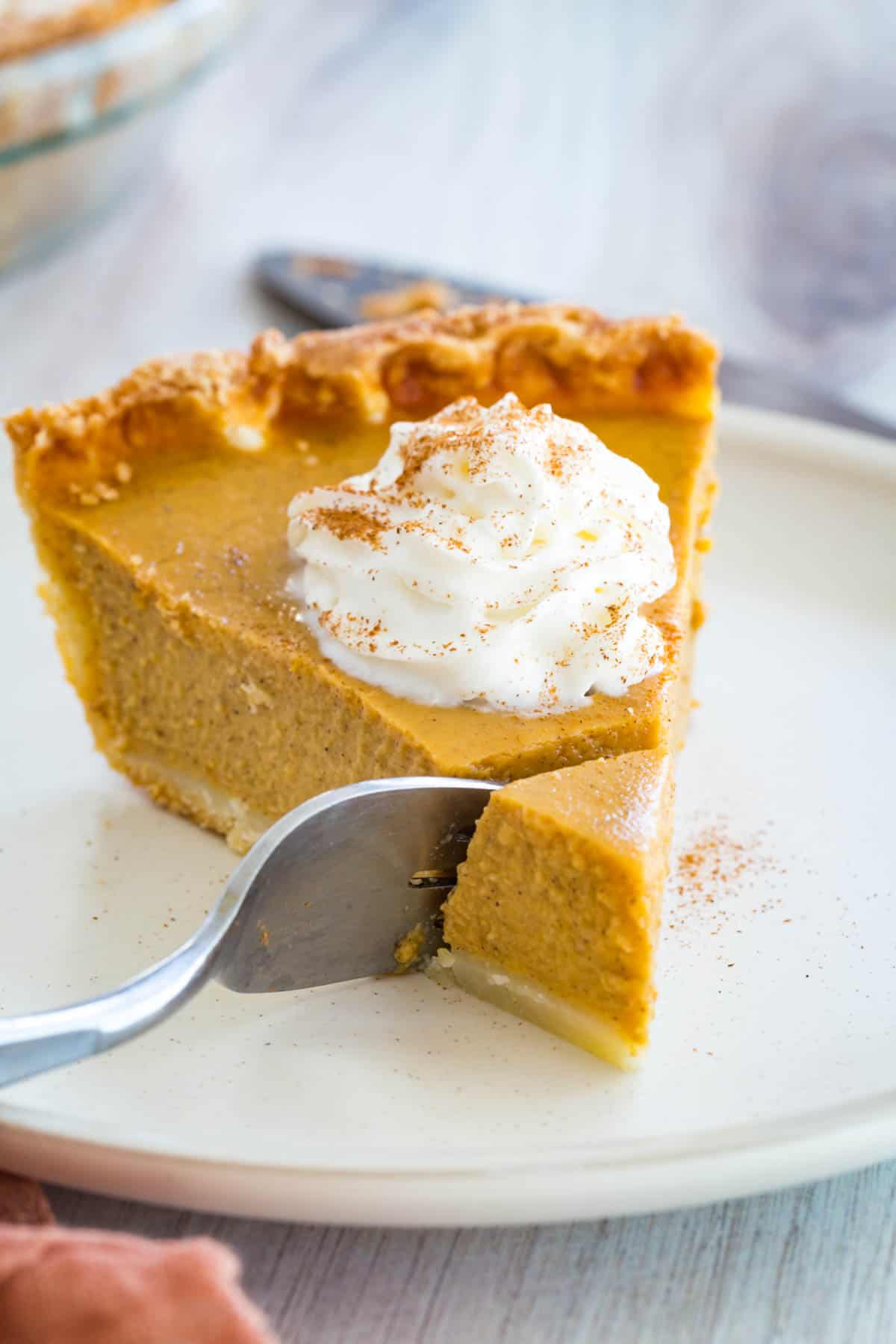 fork in a slice of pumpkin pie