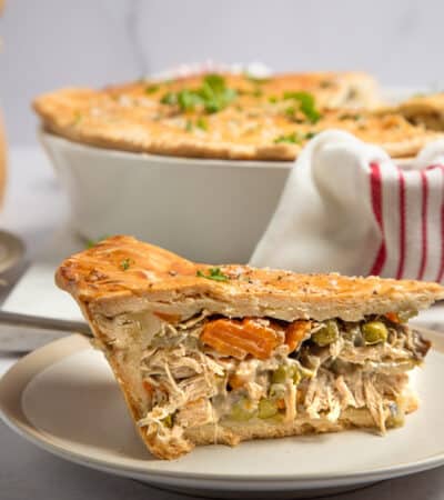 A thick slice of chicken pot pie on a plate.