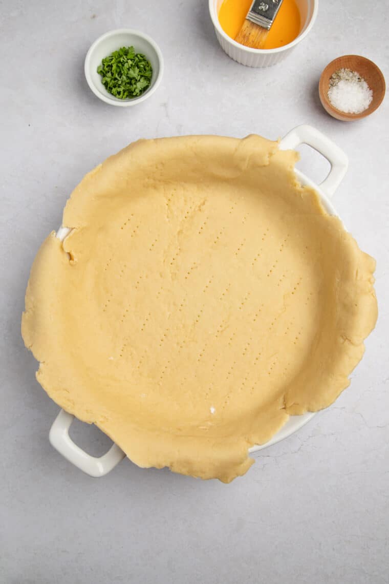 Rolled out pie dough in a pan.