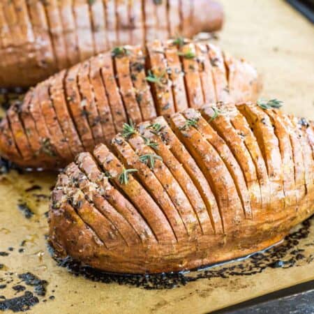 hasselback sweet potatoes on a baking sheet