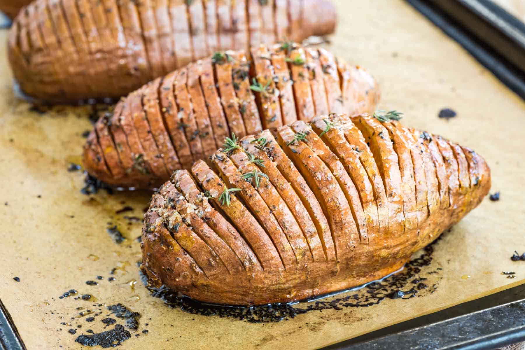 hasselback sweet potatoes on a baking sheet