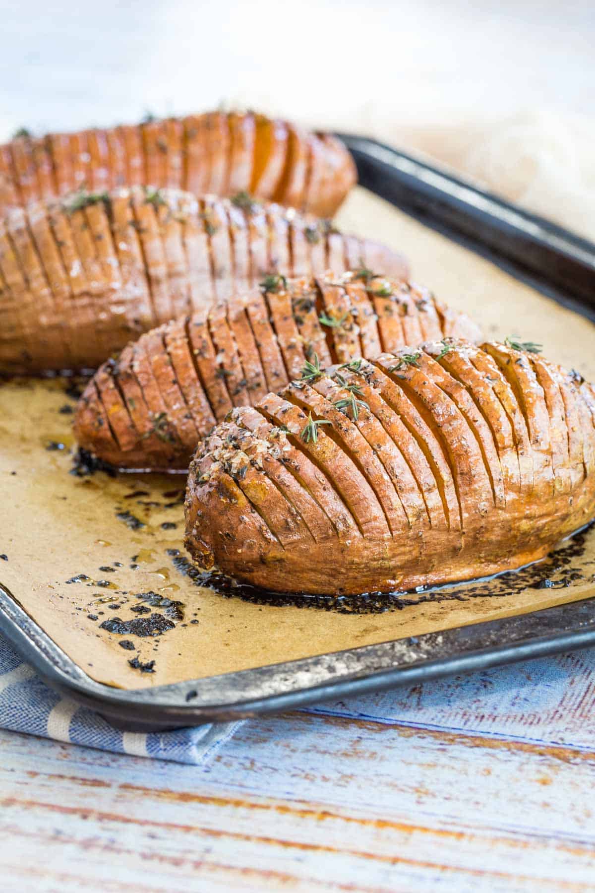 hasselback sweet potatoes on a baking sheet