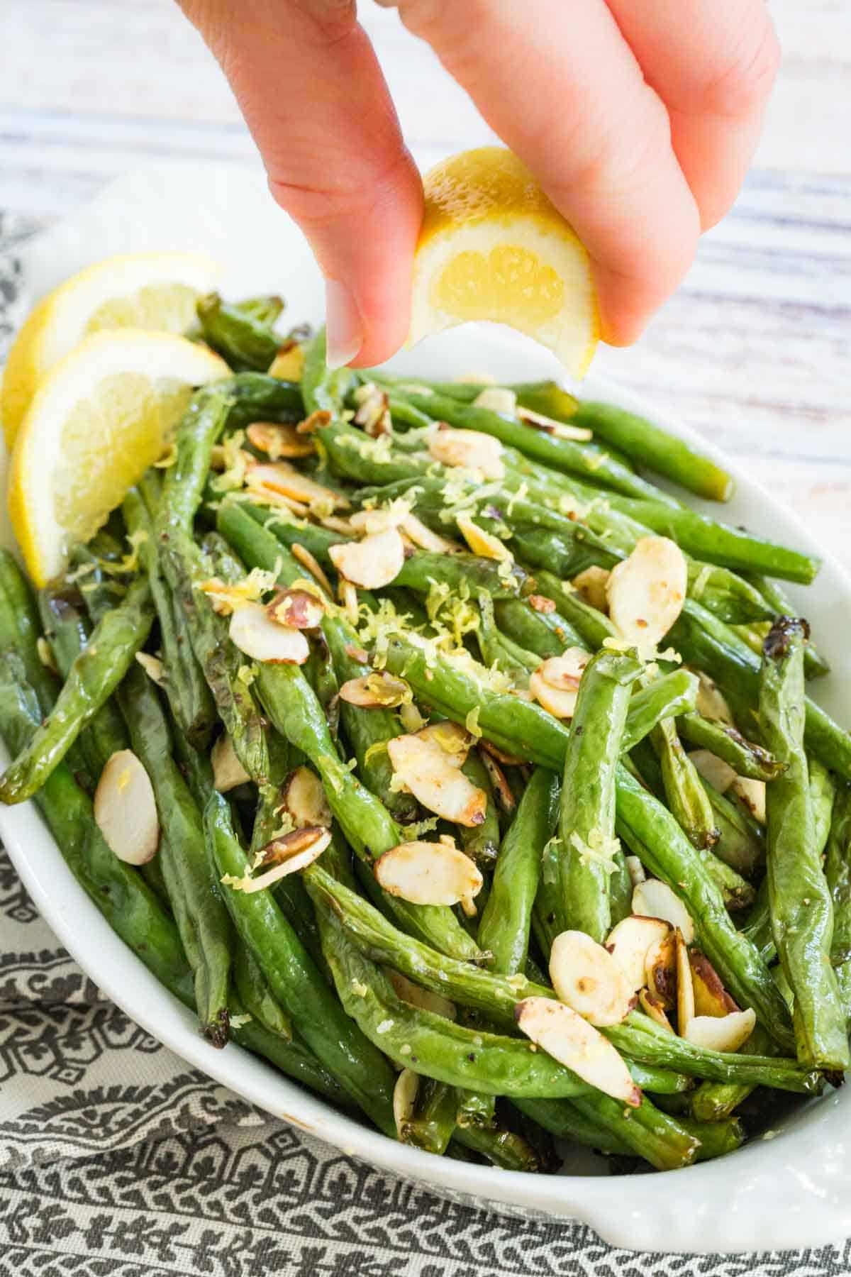 squeezing lemon on top of green beans