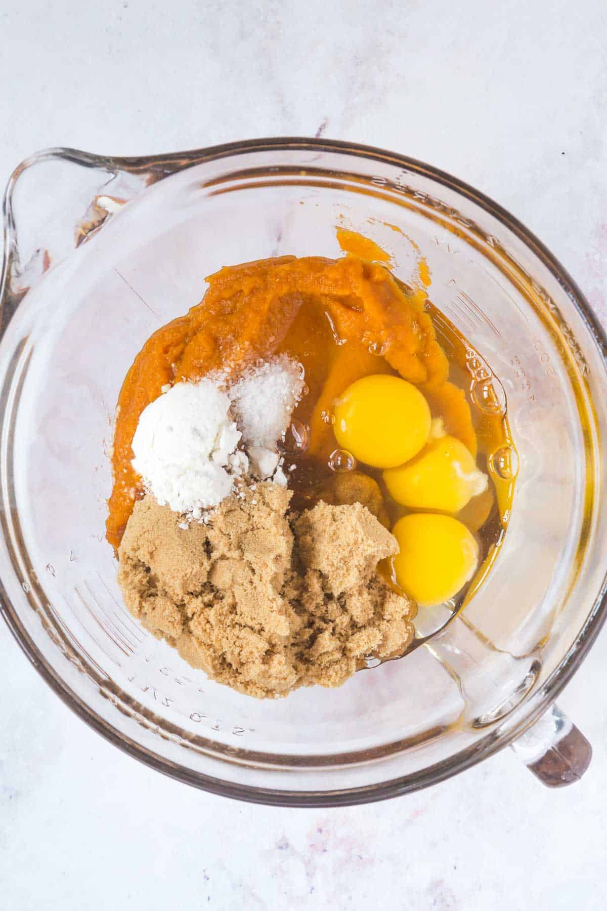 mixing bowl with eggs, salt, sugar, and pumpkin puree