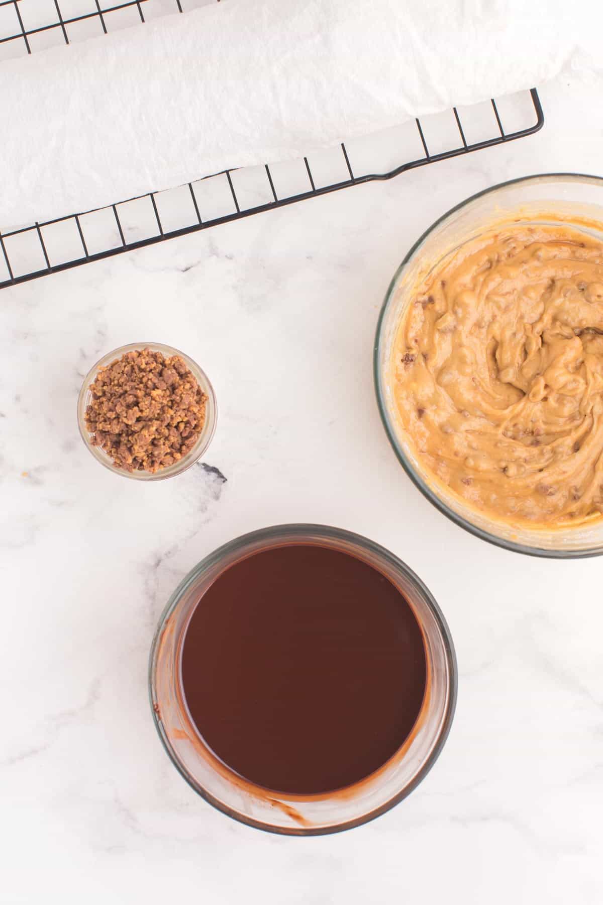 bowls of peanut butter mousse, chocolate ganache, and chopped reese's peanut butter cups