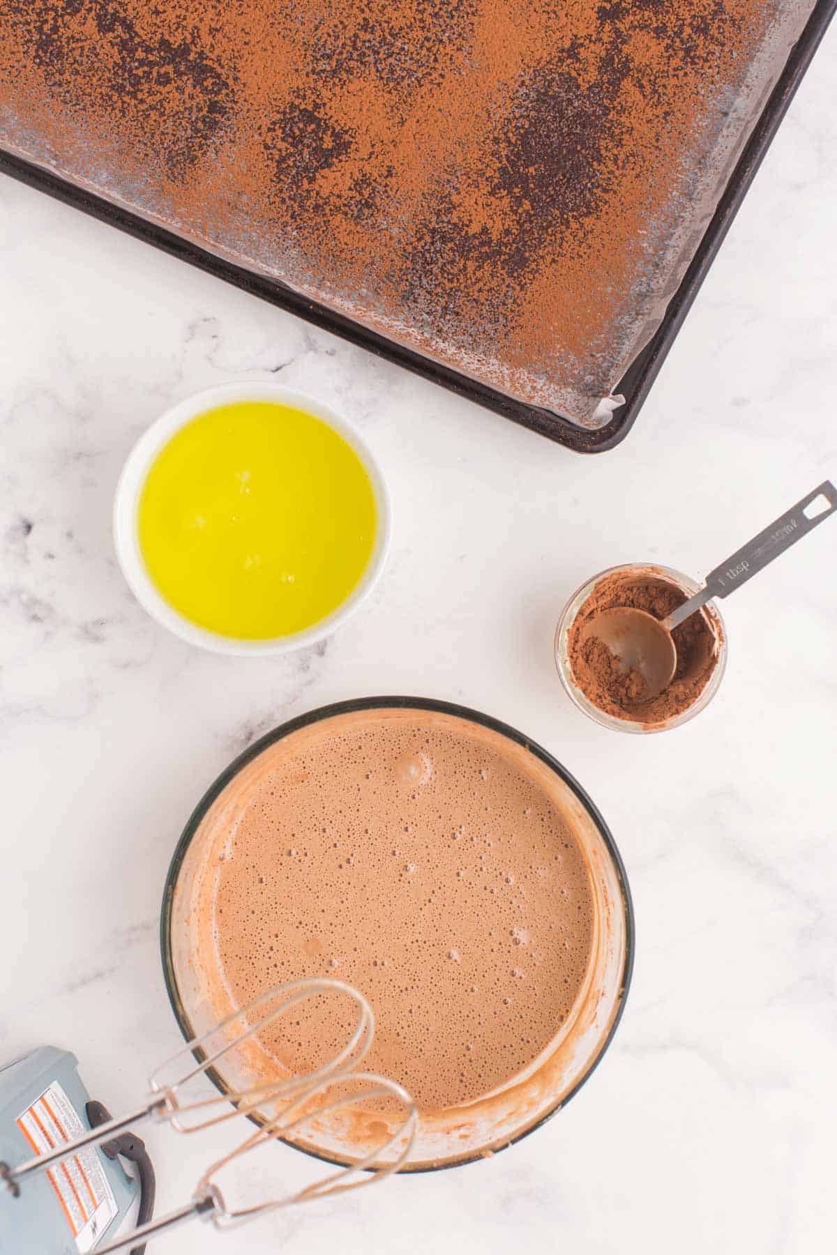 chocolate cake batter in a bowl with a mixer