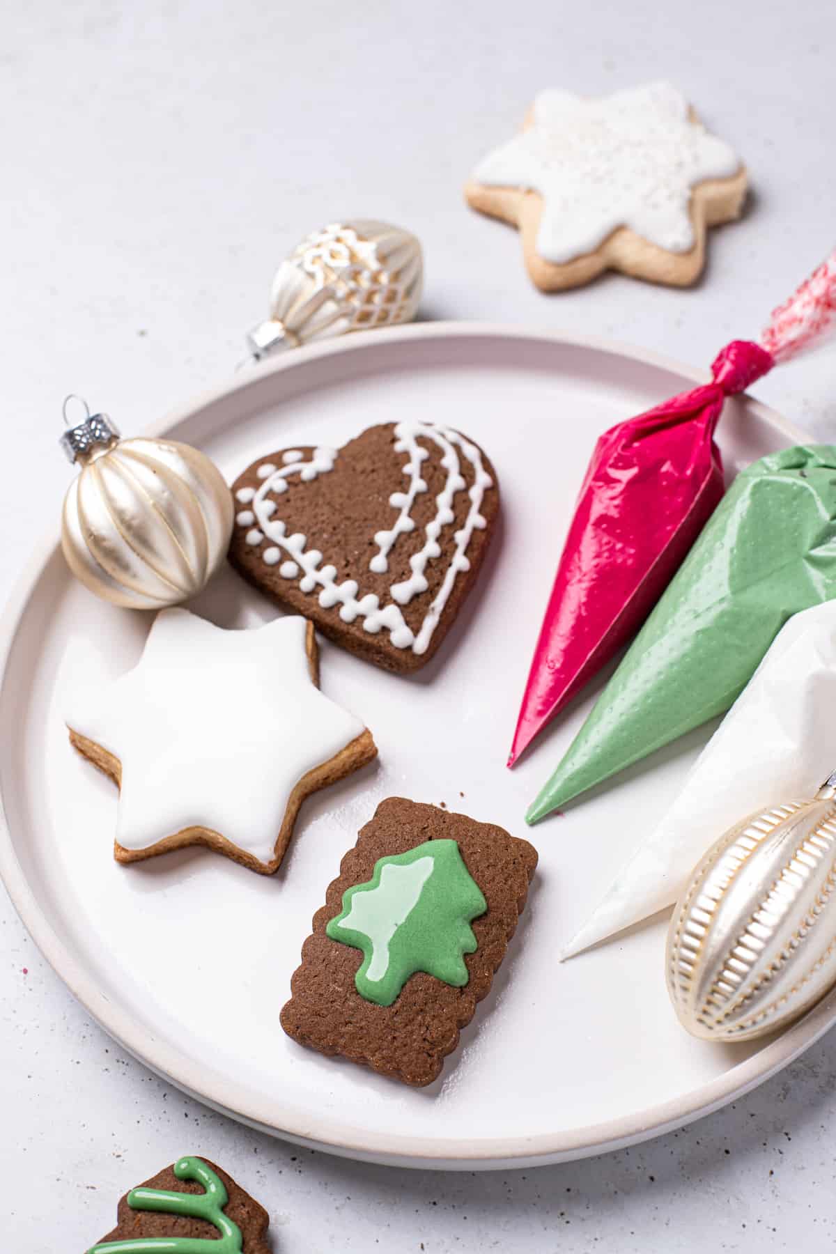 plate of christmas cookies with bags of frosting