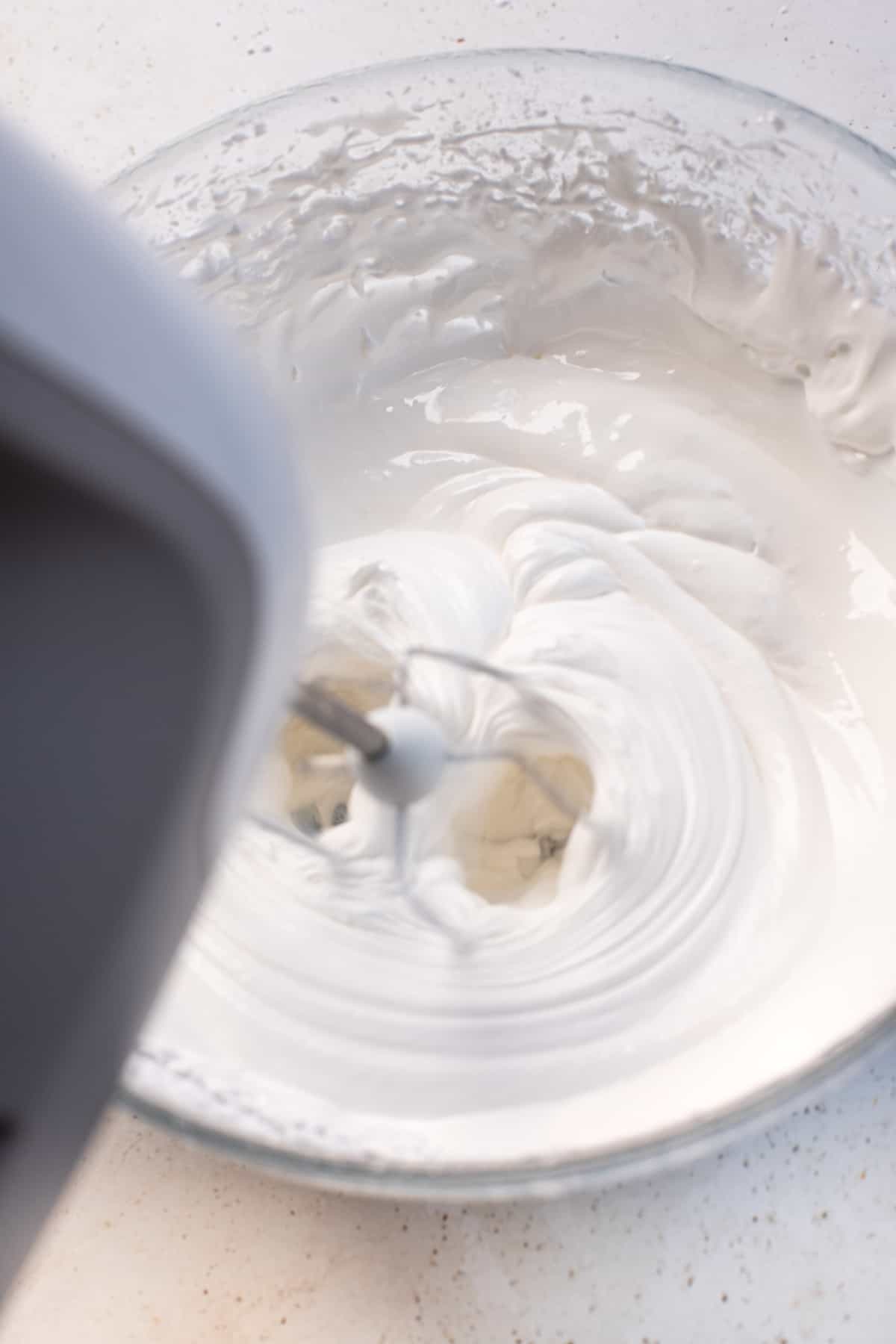 blending frosting in a bowl