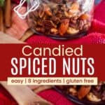 candied spiced nuts in a jar and on a small wooden spoon