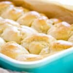 a baking pan of buttery, golden dinner rolls