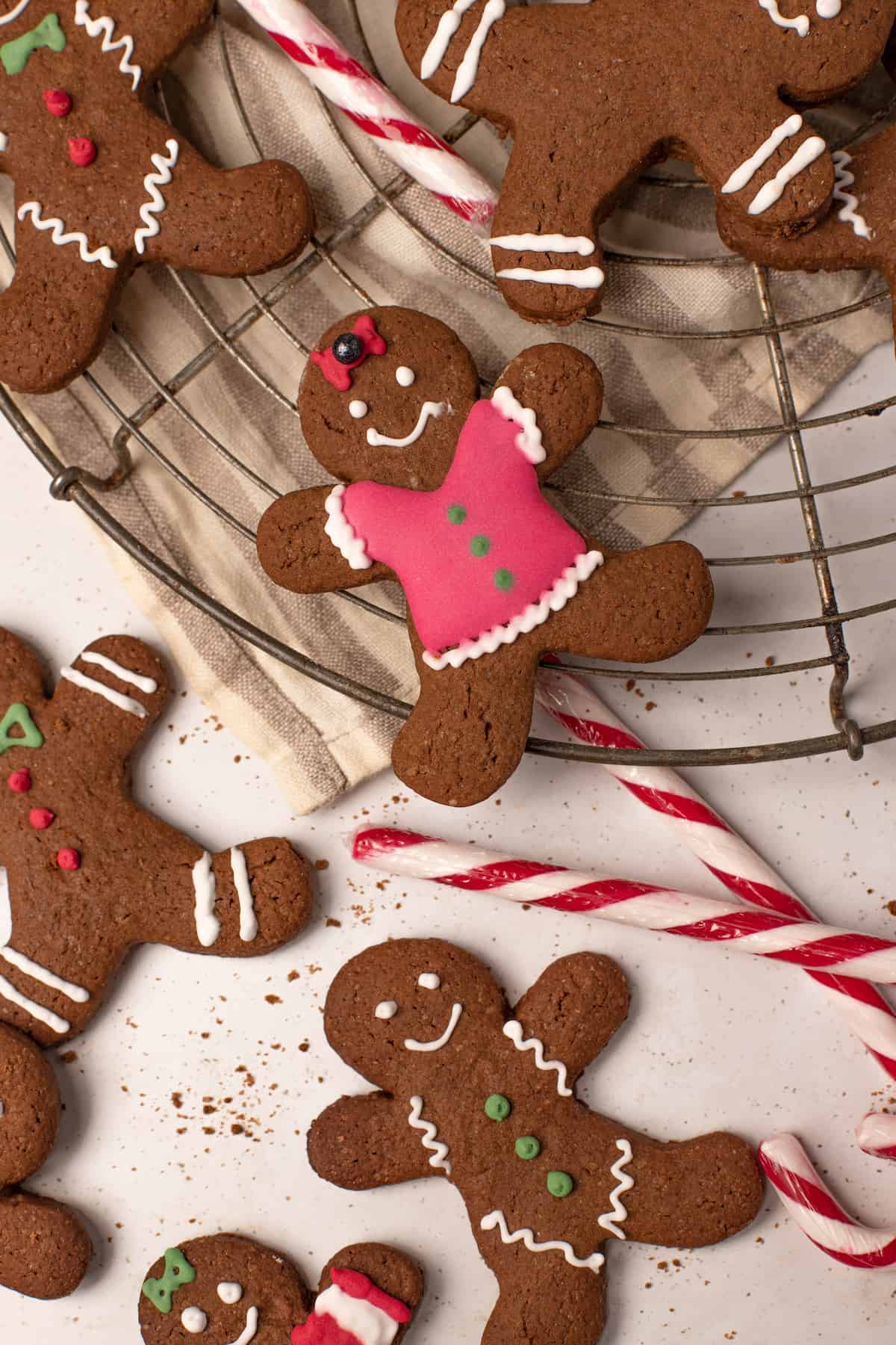 A top down shot of gluten free gingerbread cookies with candy canes.