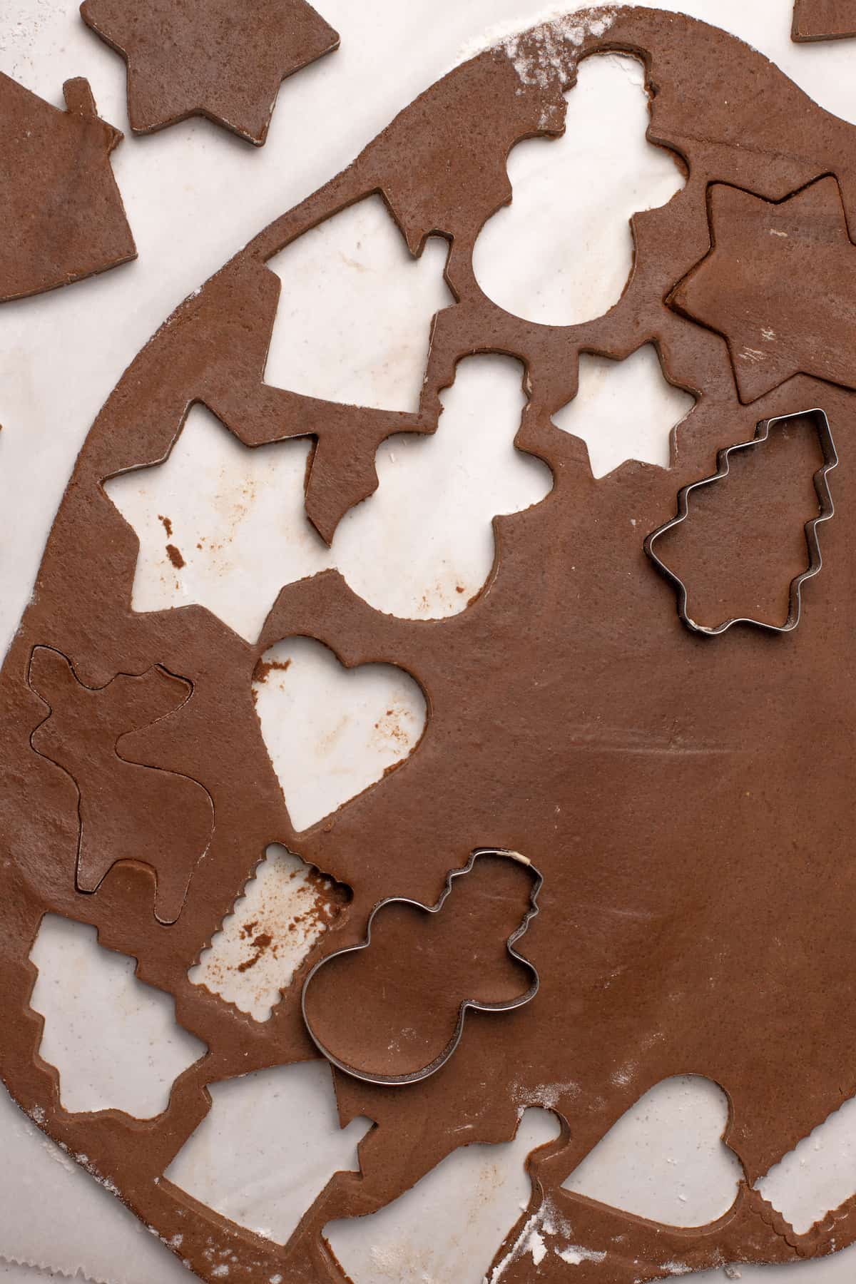 cutting gingerbread cookies out of dough